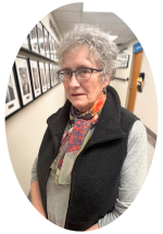 Catherine McKay standing in a hospital hallway with framed photographs displayed along the wall behind.
