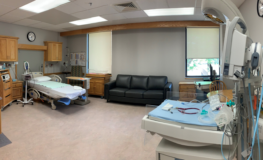 Family Centred Birthing Unit Suite with hospital bed, medical equipment, and comfortable seating area